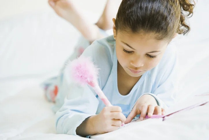 Student Writing in a Notebook